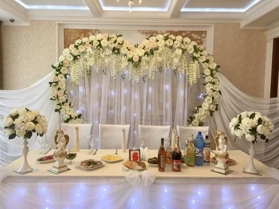 white flower heart shape backdrop for sweetheart table