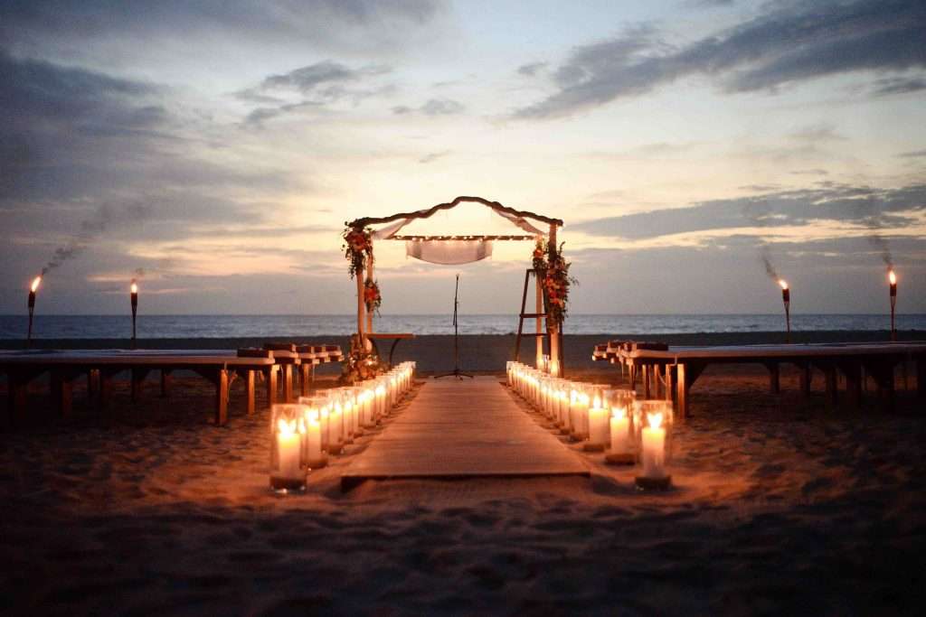 Beach ceremony with candle decor