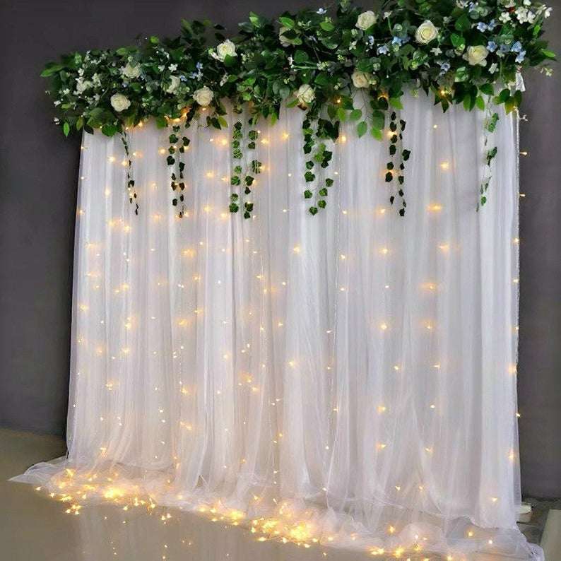 Green top drape and lights wedding backdrop