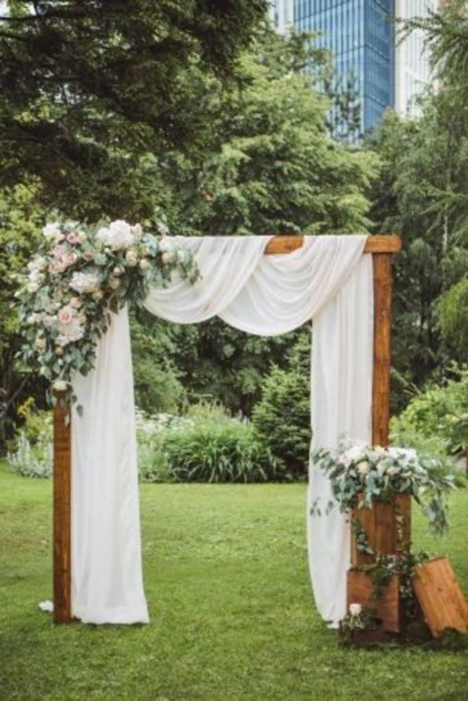Drape and flowers wedding ceremony backdrop
