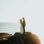 Couple on cliff by ocean