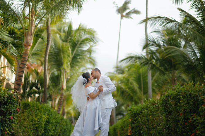 Couple kissing by palm trees